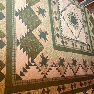 Charming Green and Cream Star Quilt.  A very good condition. Asking $50 for it.